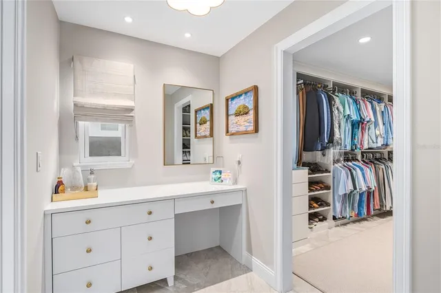 a view of walk in closet with clothes and shoes