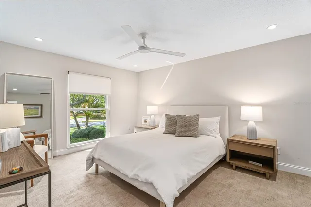 a bedroom with a bed and a large window