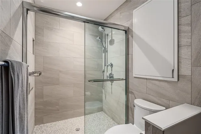 a bathroom with a glass shower door