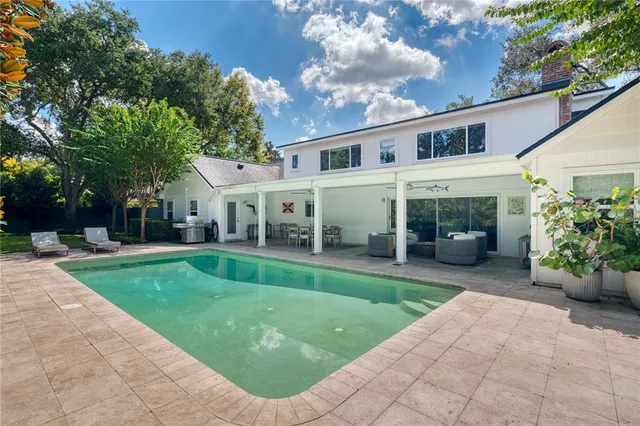 a view of a house with a yard and sitting area