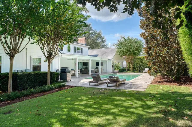 a front view of a house with garden and sitting area