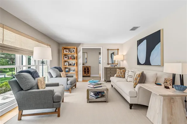 a living room with furniture ceiling fan and a window