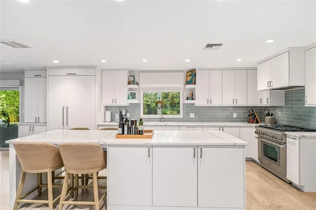 a kitchen with sink cabinets and dining table