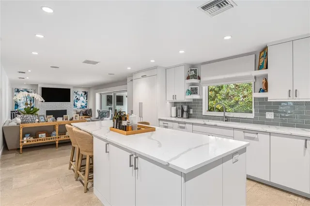 a kitchen with a stove a sink and a refrigerator