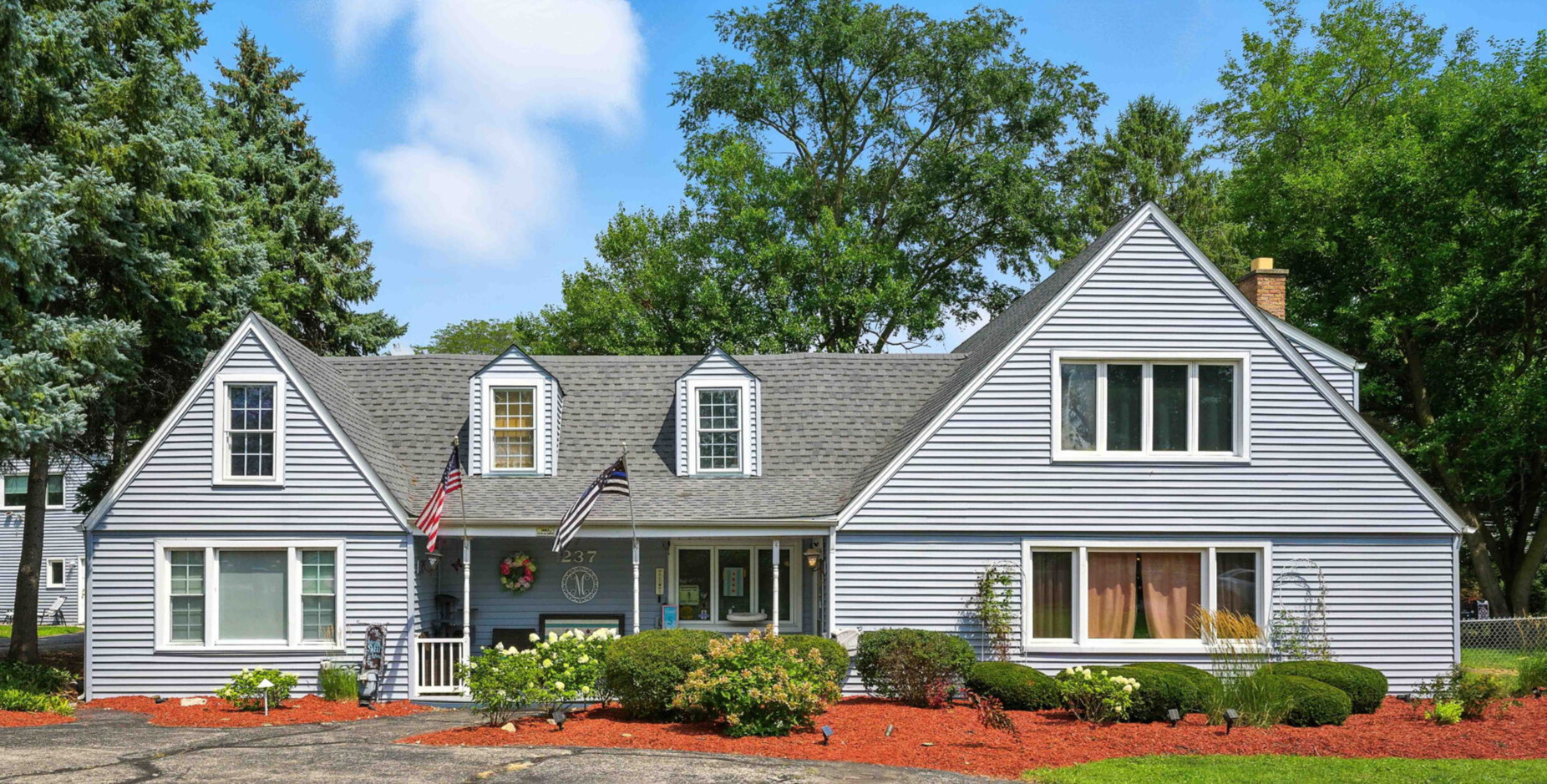 a front view of a house with garden