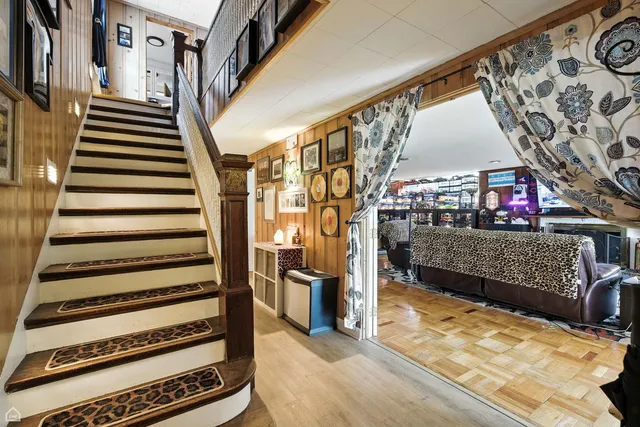 a living room with furniture fireplace and a large window