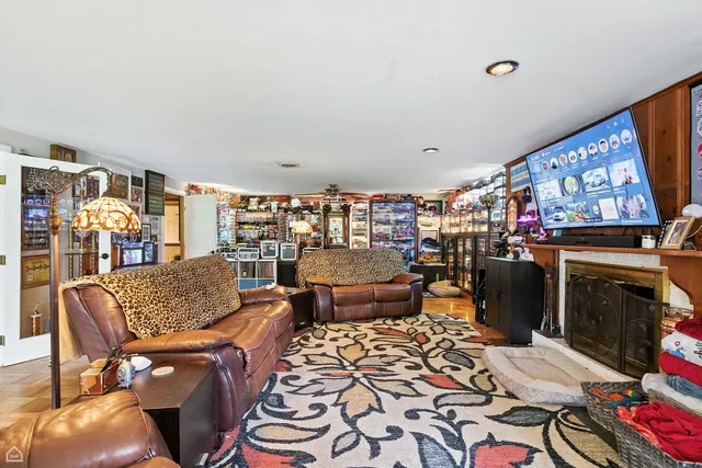 a living room with furniture a fireplace and a flat screen tv