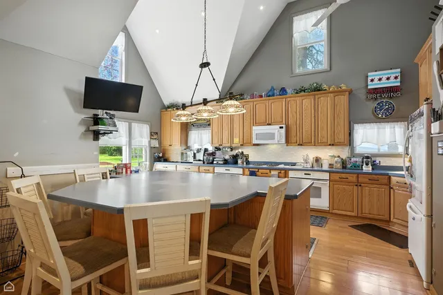a living room with furniture a wooden floor and gym equipment