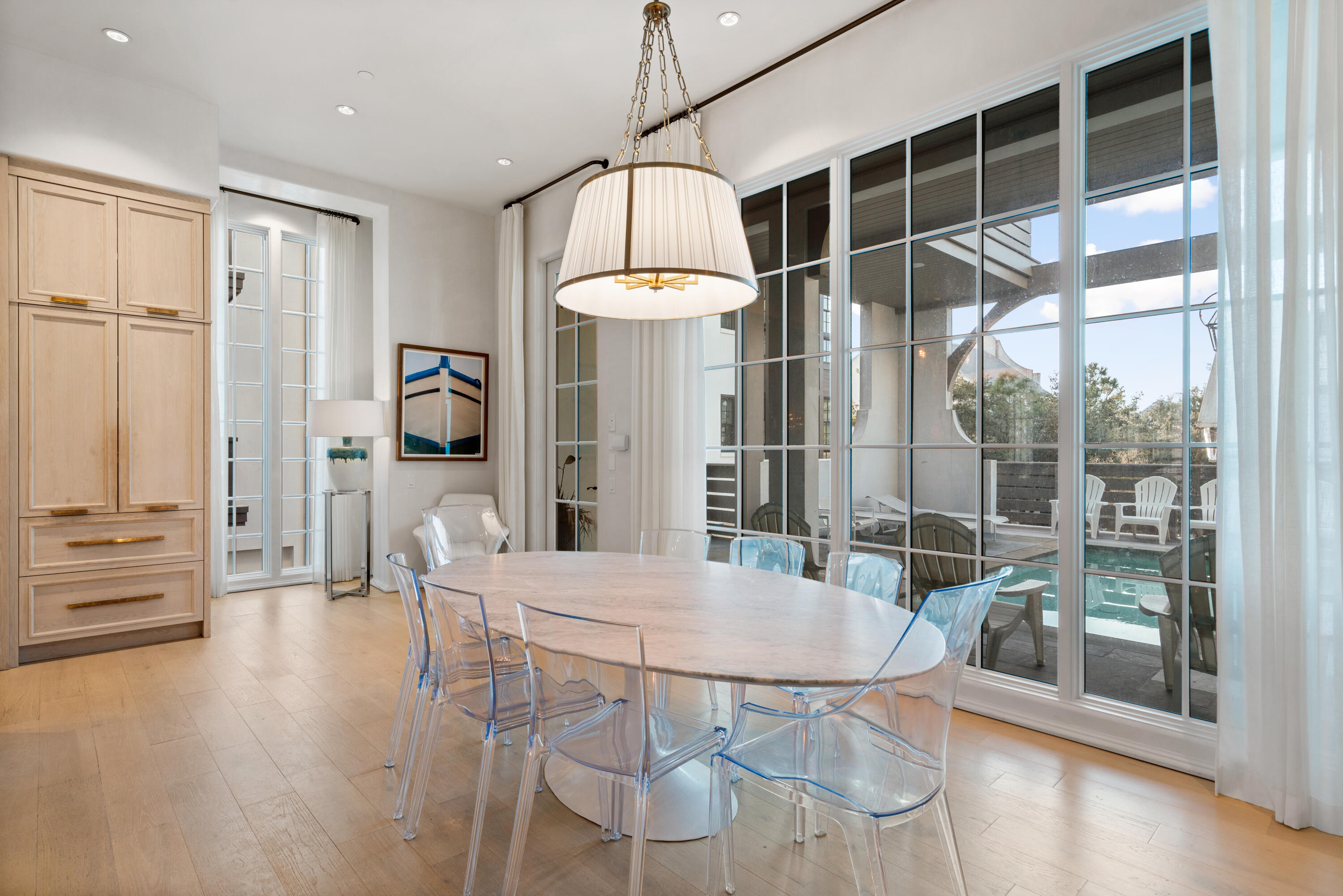 16 South Barrett Square, Unit 5 Rosemary Beach, FL 32461 - Photo 20 of 100 a dining room with furniture a chandelier and wooden floor