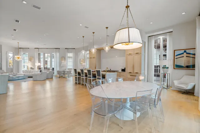a spacious bathroom with a double vanity sink a large mirror and a shower