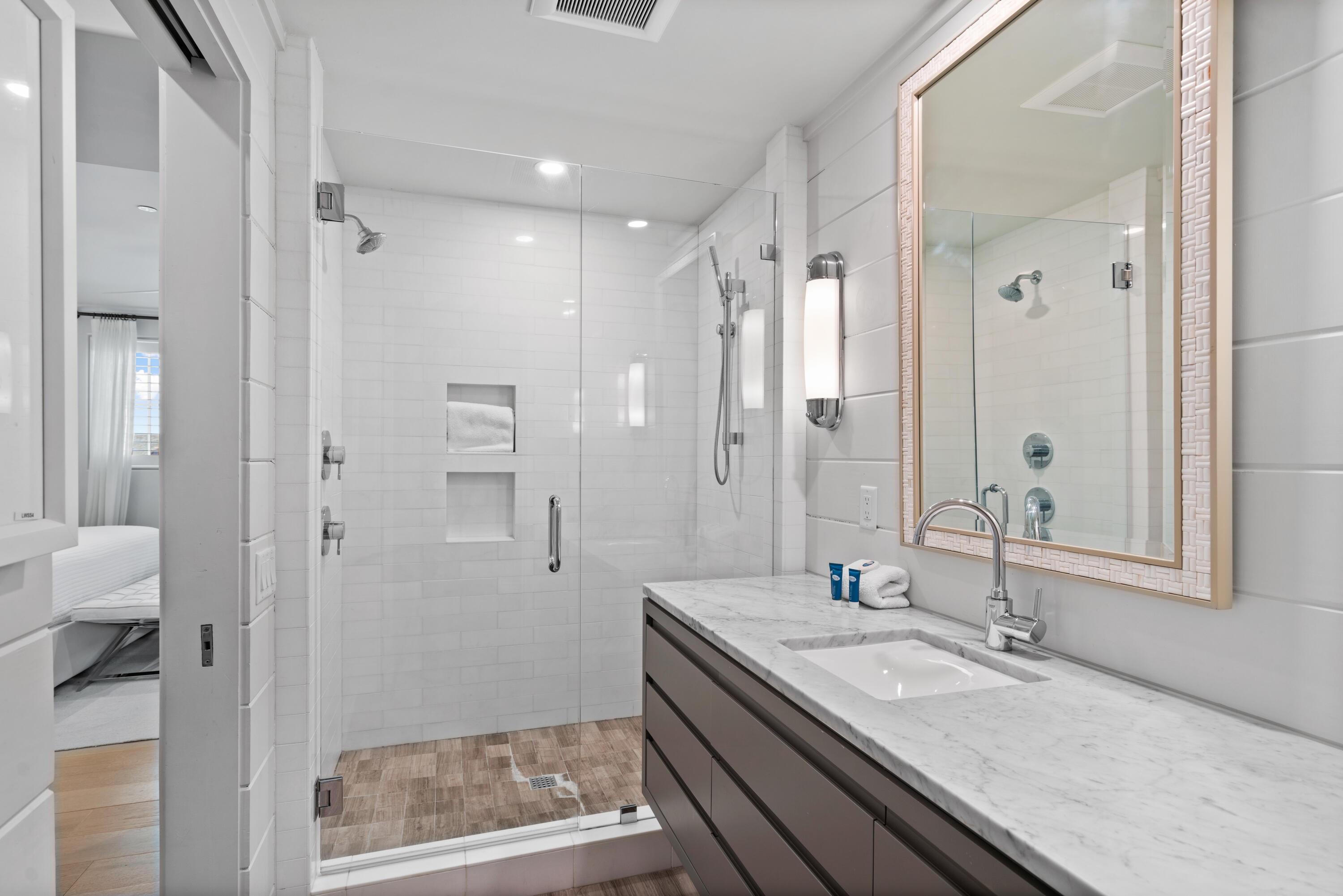 16 South Barrett Square, Unit 5 Rosemary Beach, FL 32461 - Photo 71 of 100 a bathroom with a granite countertop sink a mirror and a shower