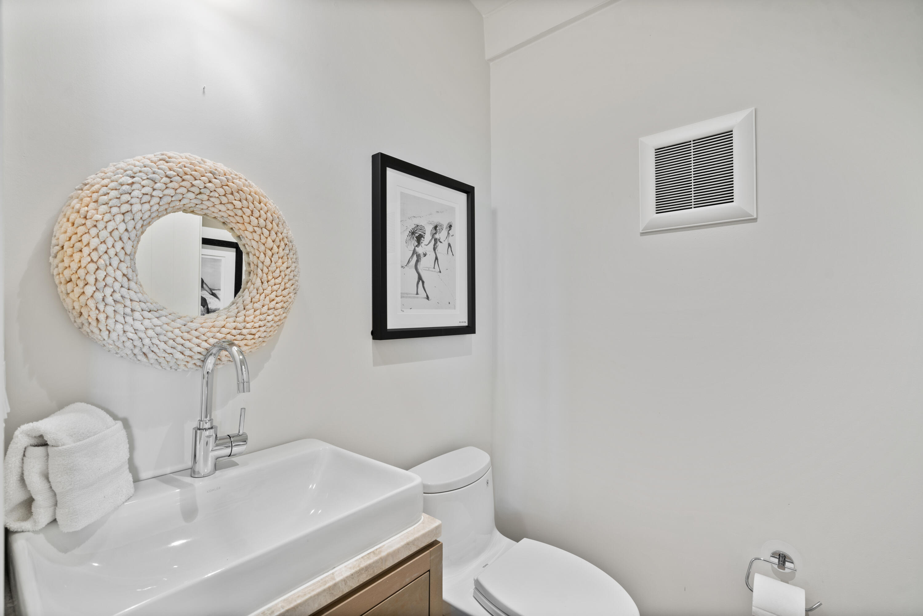 16 South Barrett Square, Unit 5 Rosemary Beach, FL 32461 - Photo 76 of 100 a bathroom with a toilet a sink and mirror