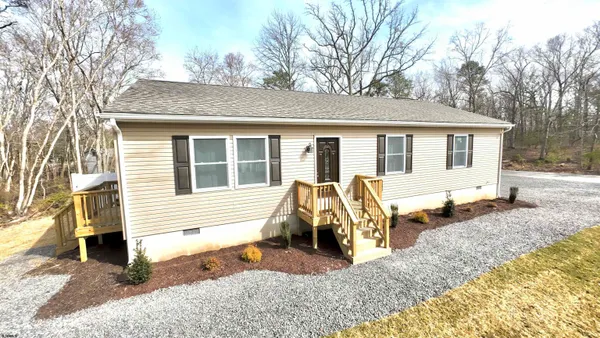 a view of a house with a patio and backyard