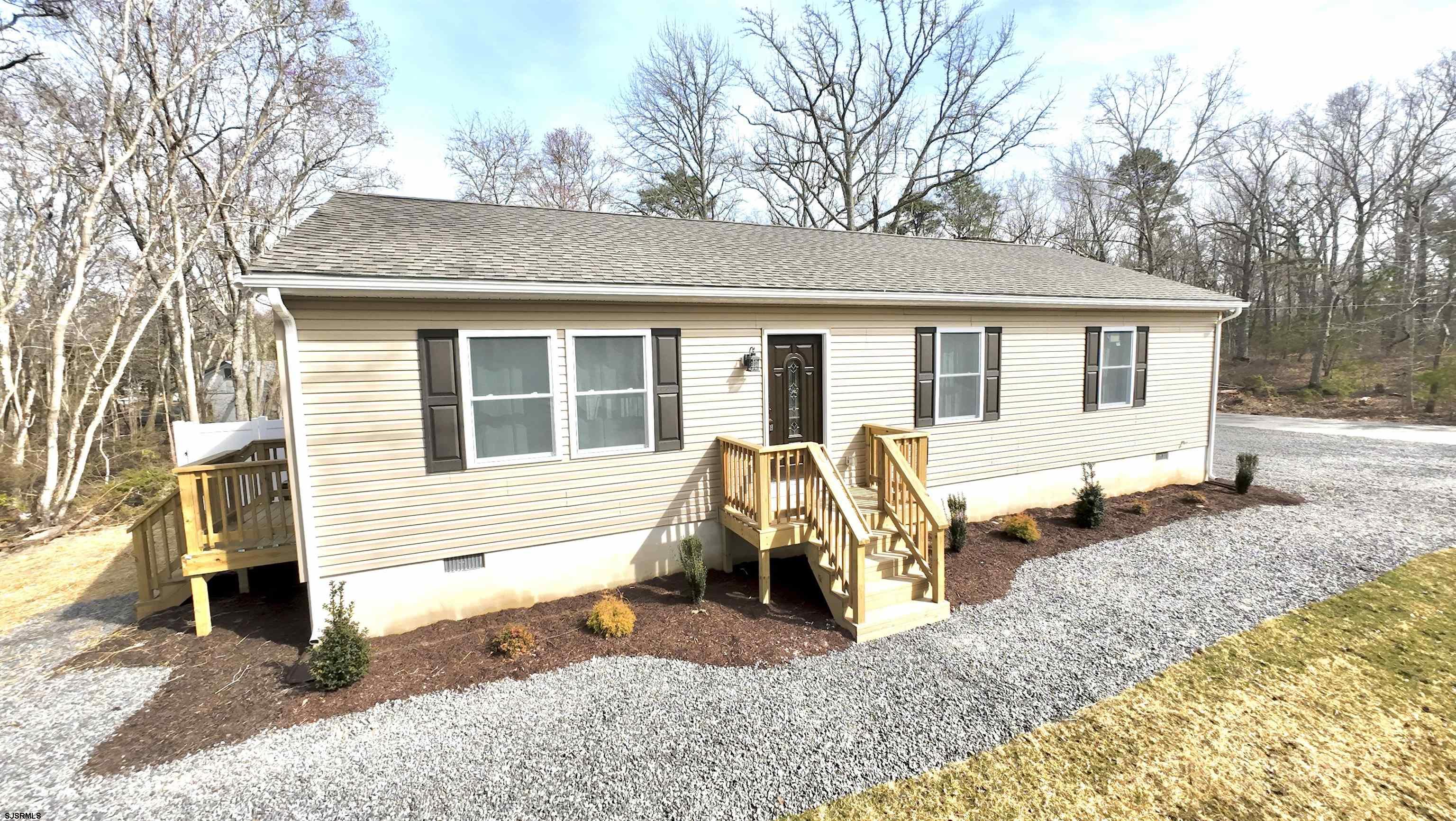 a view of a house with a patio and backyard