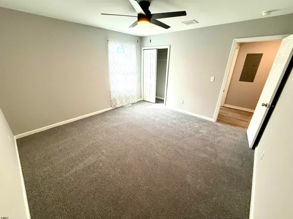 a spacious bathroom with a double vanity sink toilet and shower