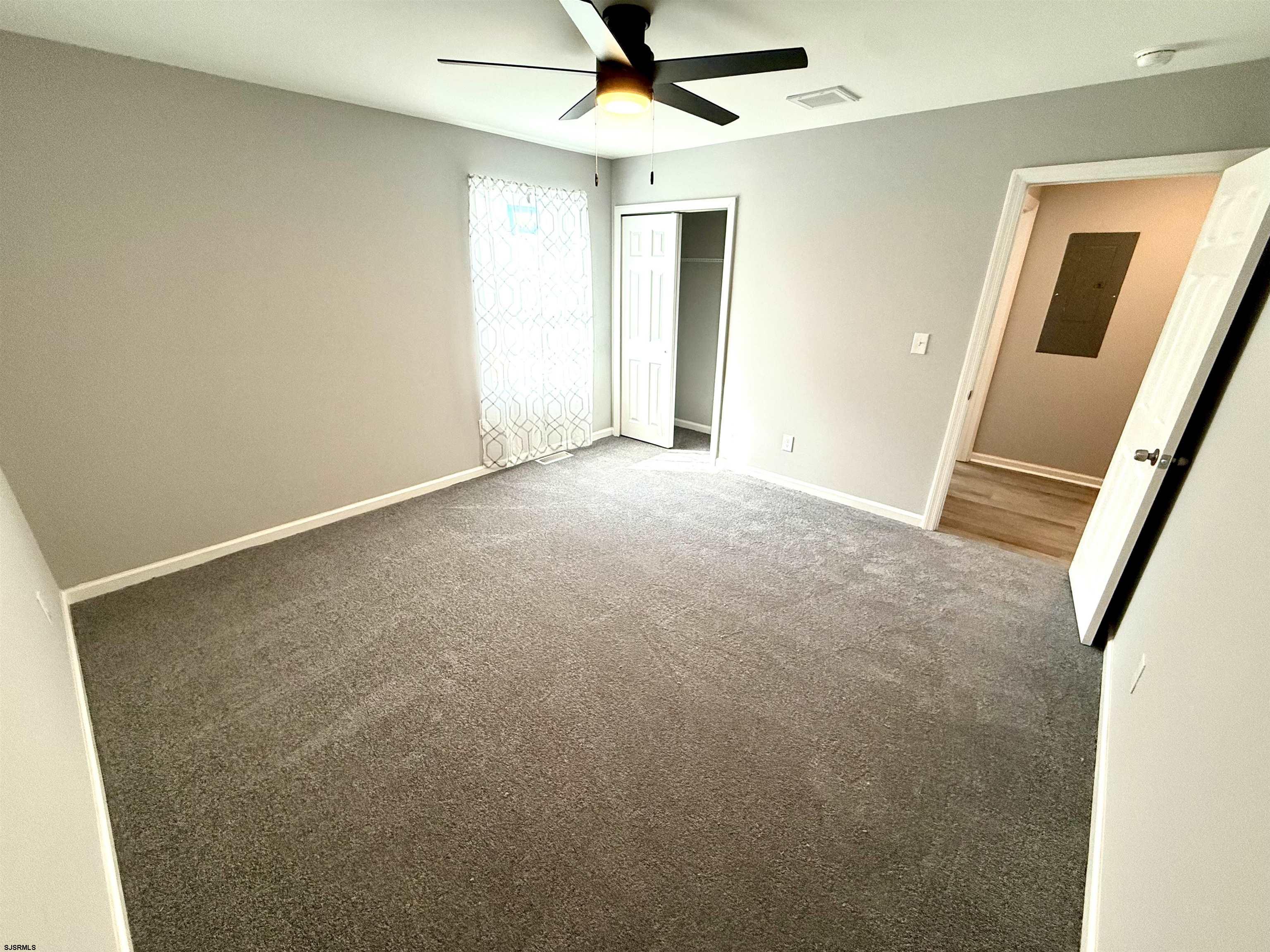 607 Sea Ranch Avenue Mays Landing, NJ 08330 - Photo 12 of 23 an empty room with a ceiling fan and window