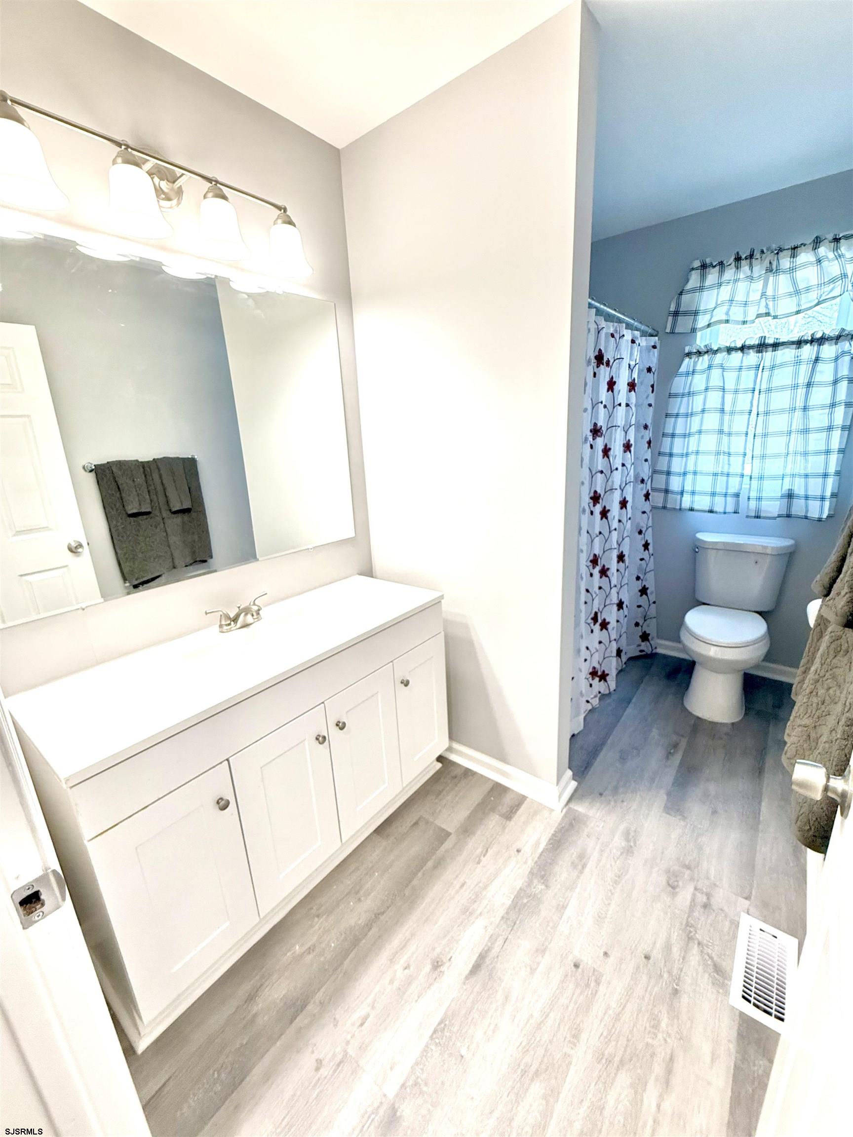 607 Sea Ranch Avenue Mays Landing, NJ 08330 - Photo 13 of 23 a spacious bathroom with a double vanity sink toilet and shower