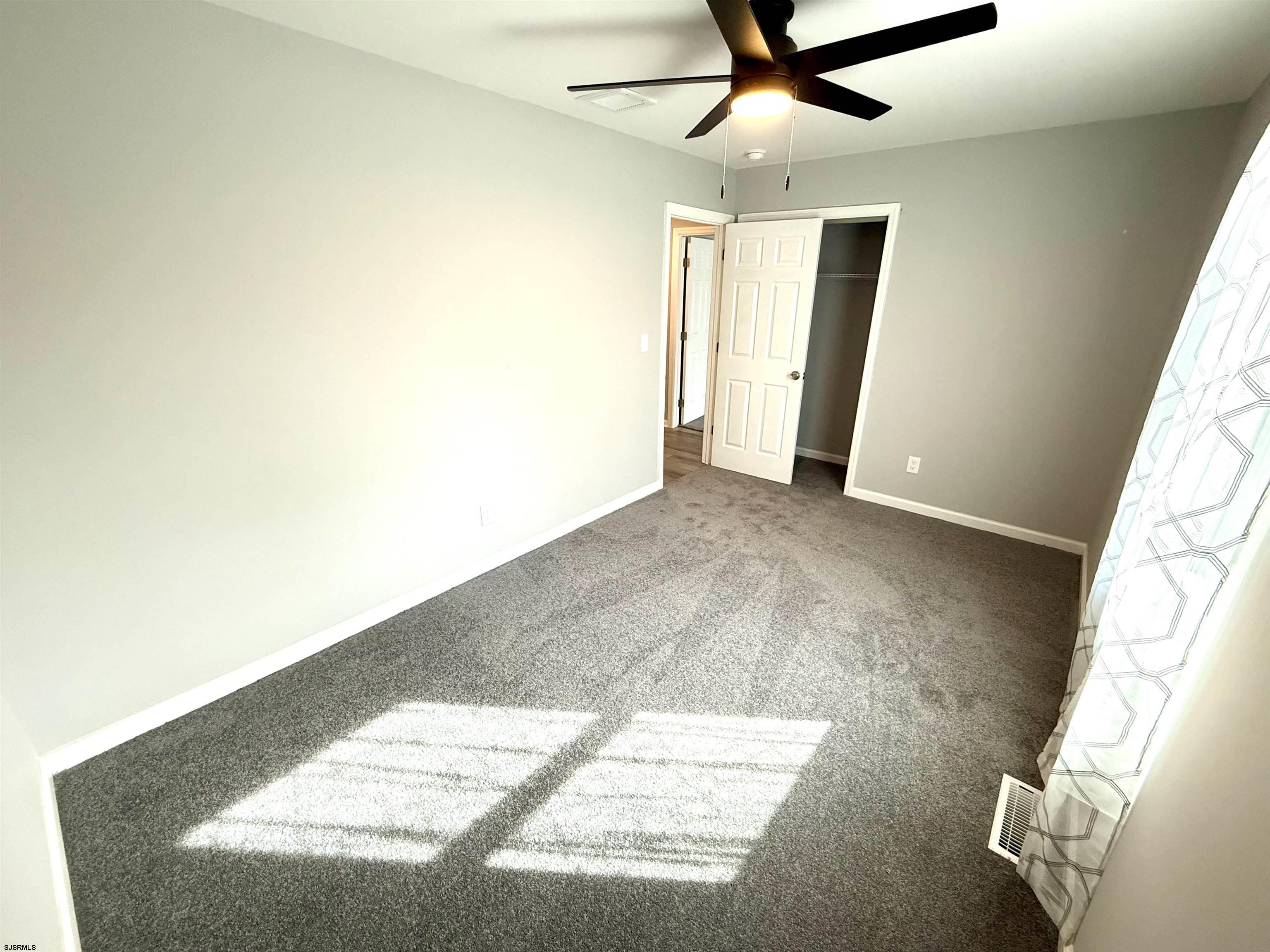 607 Sea Ranch Avenue Mays Landing, NJ 08330 - Photo 14 of 23 a view of a livingroom with a ceiling fan and window