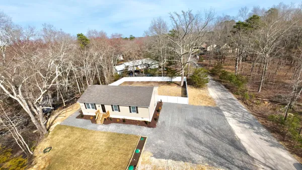 an aerial view of a house with a yard