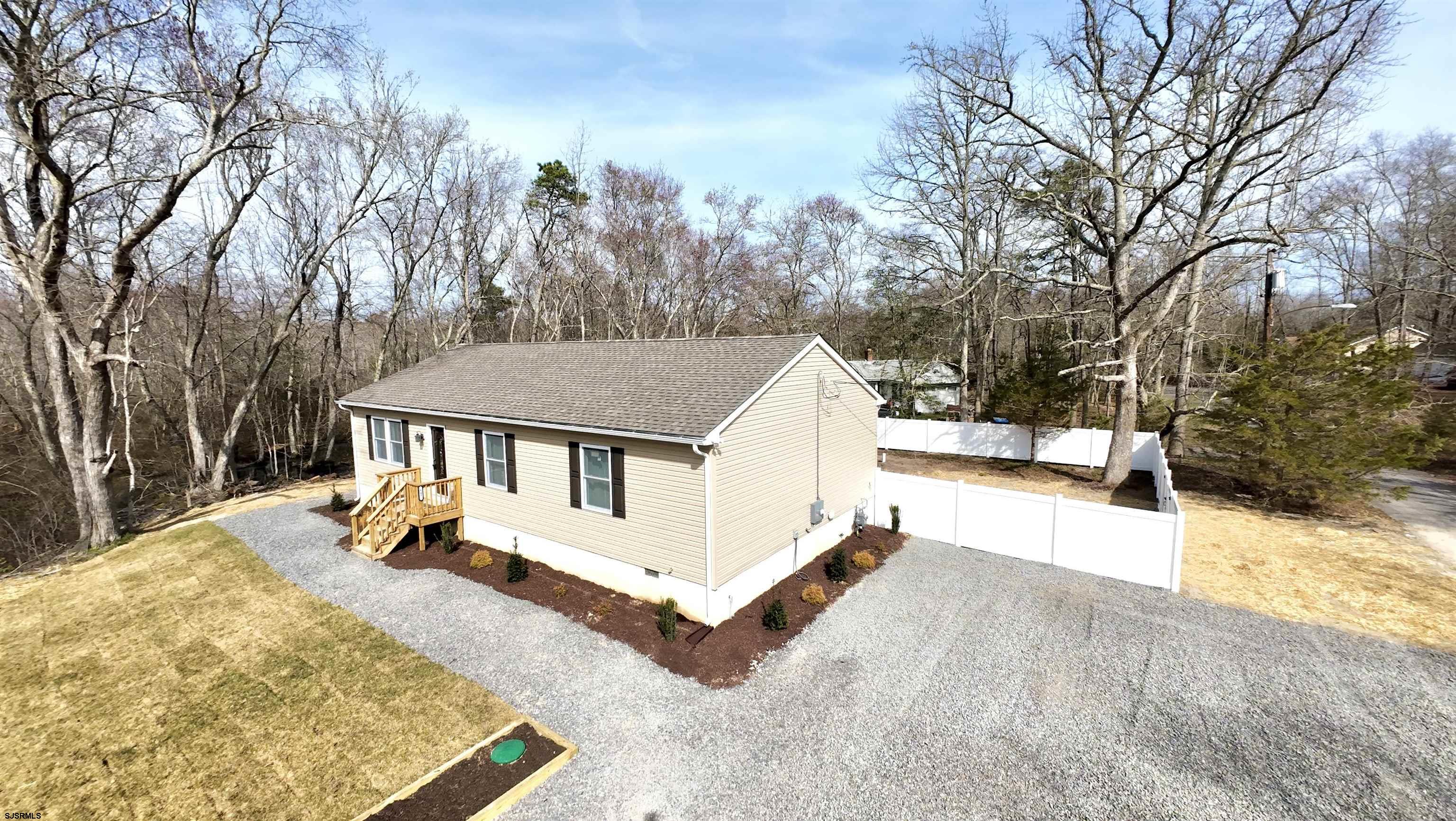607 Sea Ranch Avenue Mays Landing, NJ 08330 - Photo 2 of 23 a view of a house with a yard covered in snow