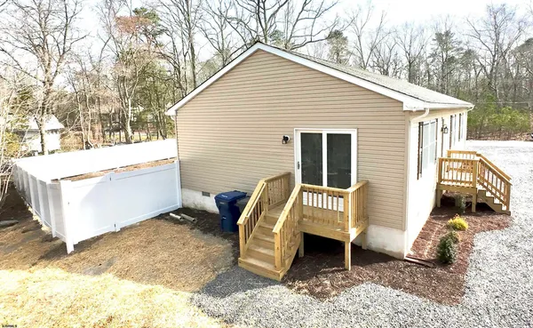 a view of a house with a yard and furniture
