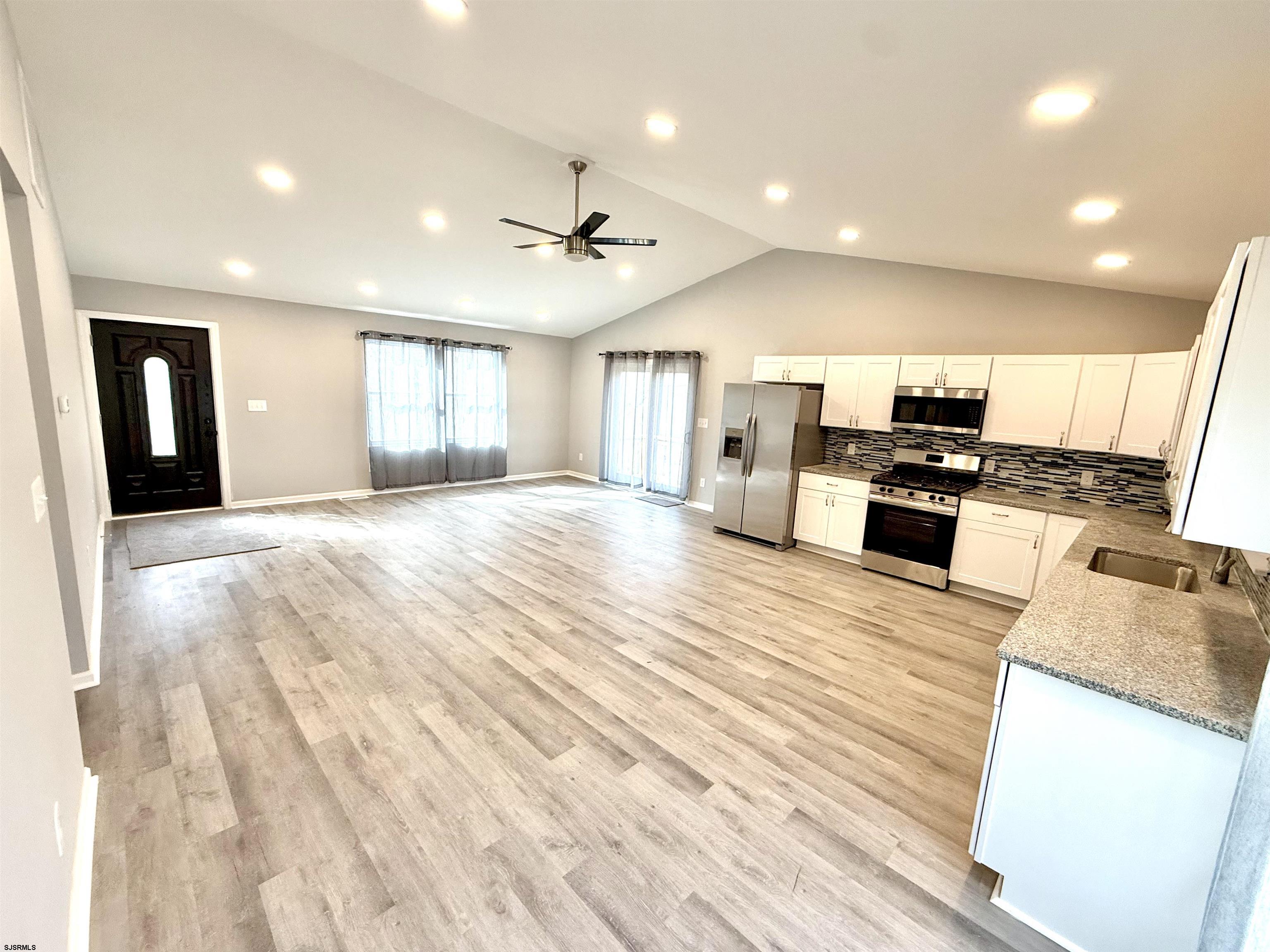 607 Sea Ranch Avenue Mays Landing, NJ 08330 - Photo 6 of 23 a large kitchen with kitchen island a stove a sink dishwasher and a oven with wooden floor
