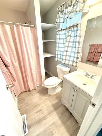 a view of a big room with closet and windows
