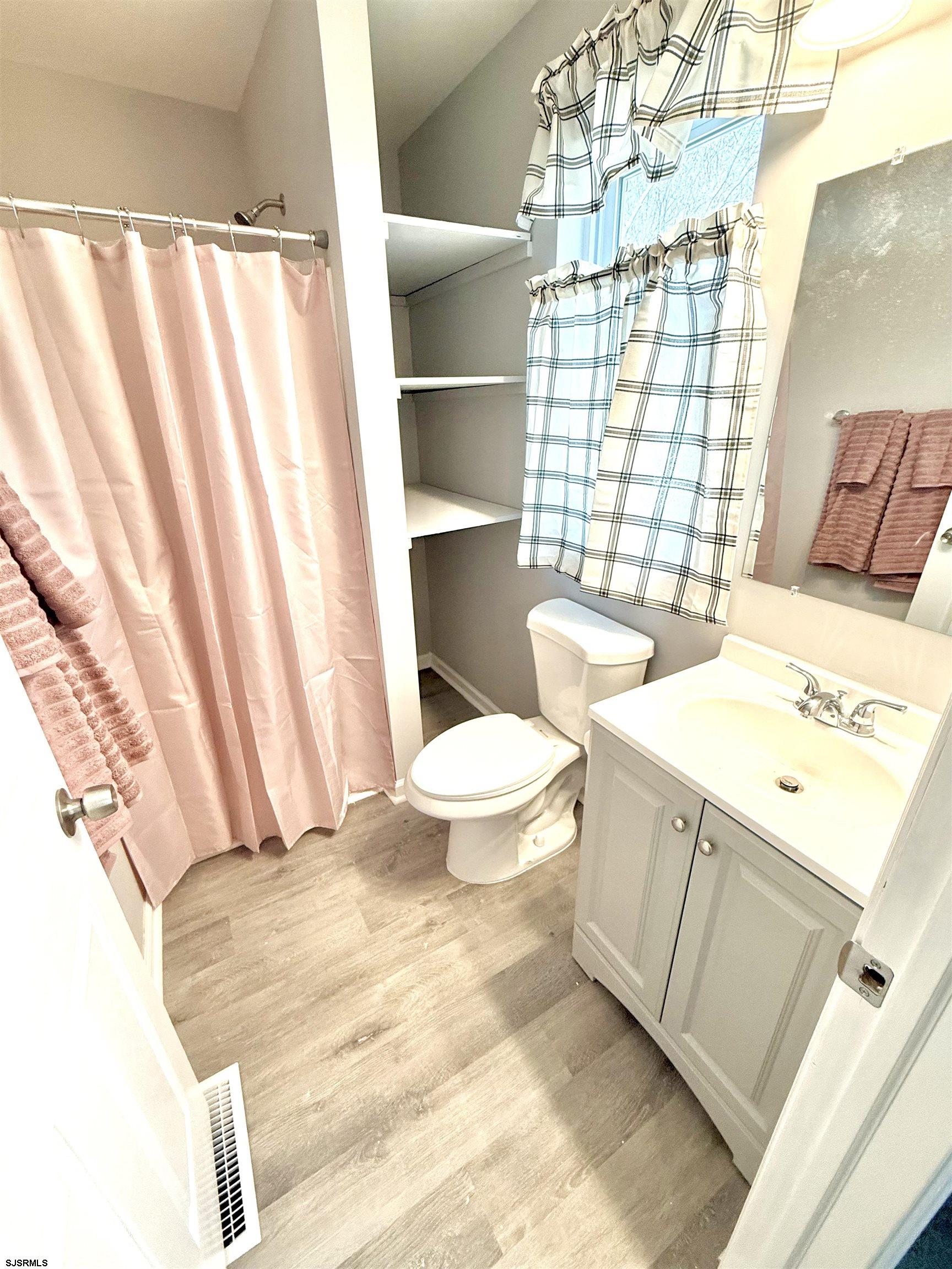 607 Sea Ranch Avenue Mays Landing, NJ 08330 - Photo 10 of 23 a bathroom with a sink a toilet and shower curtain