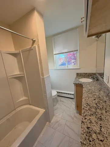 a bathroom with a bathtub and a shower