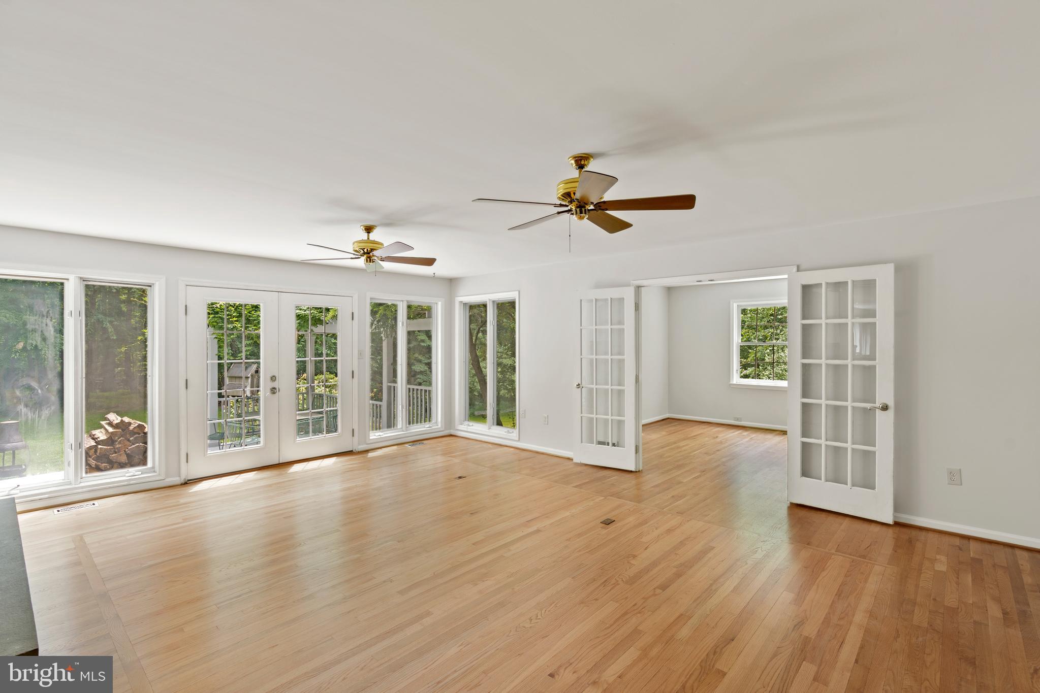 713 Clear Spring Road Great Falls, VA 22066 - Photo 14 of 41 Very large family room w wall of doors and windows