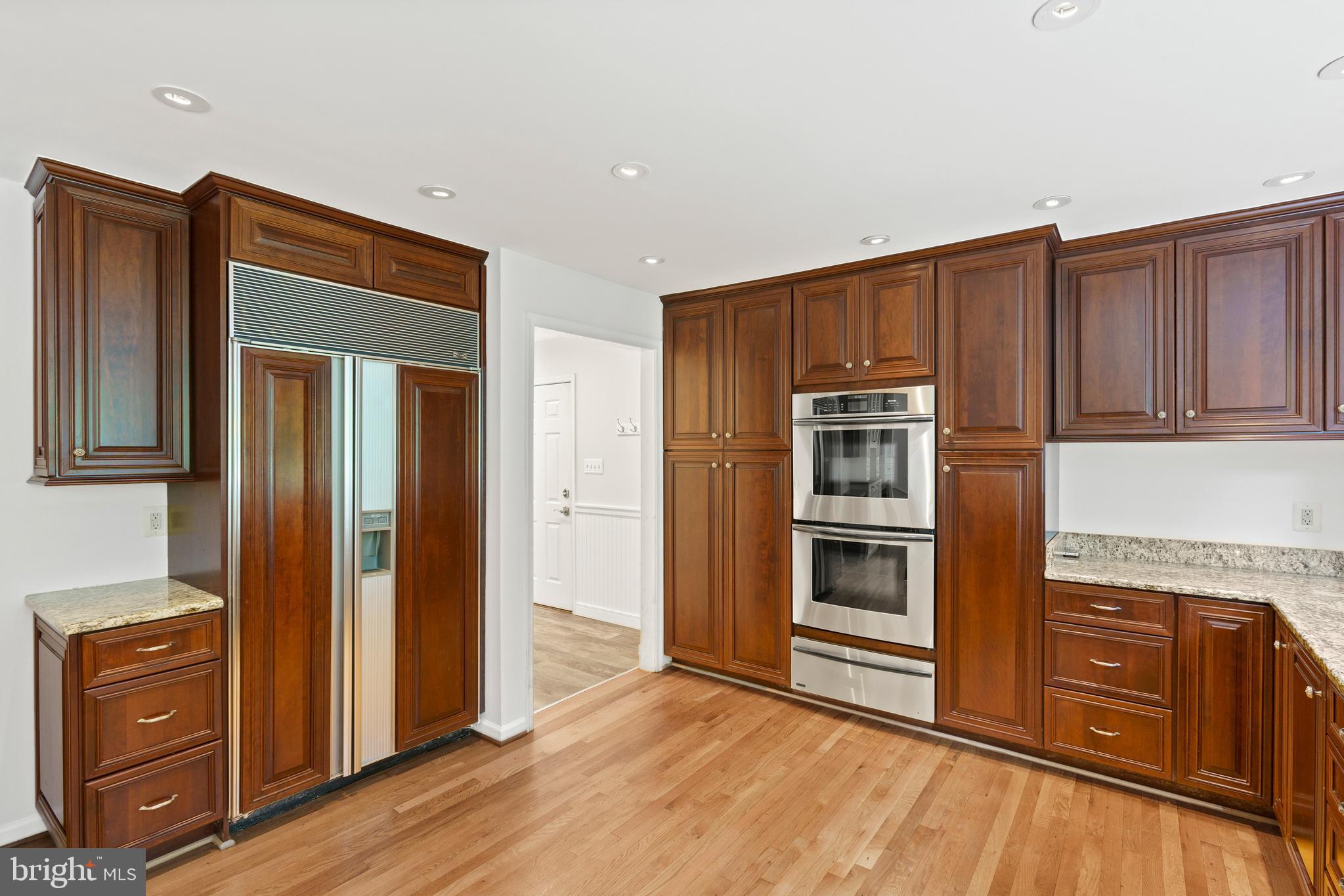 713 Clear Spring Road Great Falls, VA 22066 - Photo 10 of 41 Custom cherry cabinets with double wall ovens.