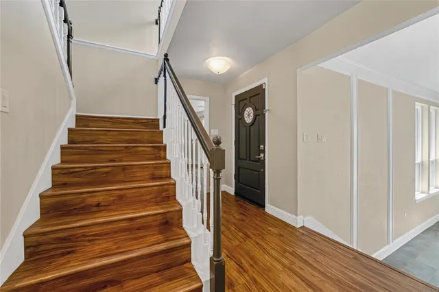 a view of entryway and hall with wooden floor