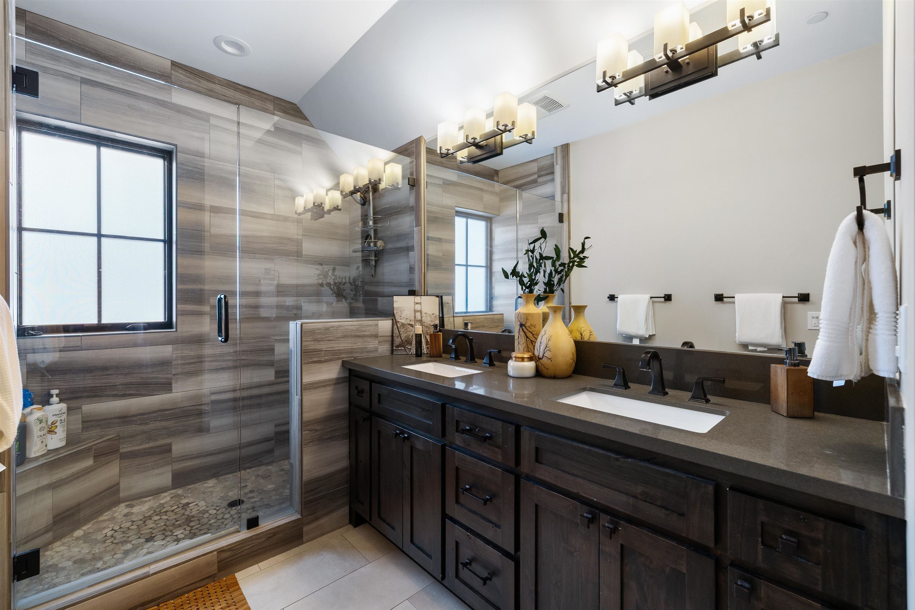 10601 Carson Range Road Truckee, CA 96161 - Photo 23 of 25 a bathroom with a double vanity sink a mirror and a shower
