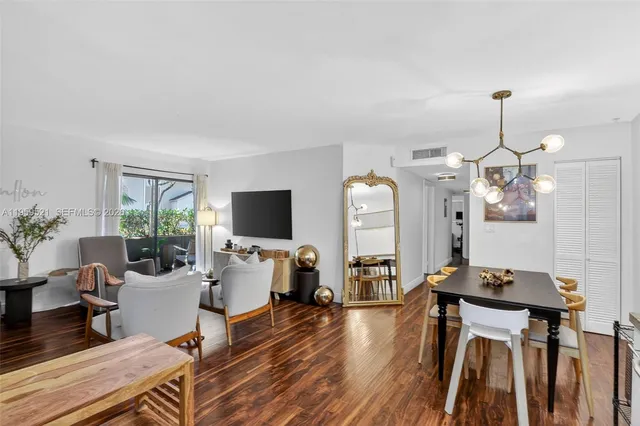 a living room with furniture a flat screen tv and a table