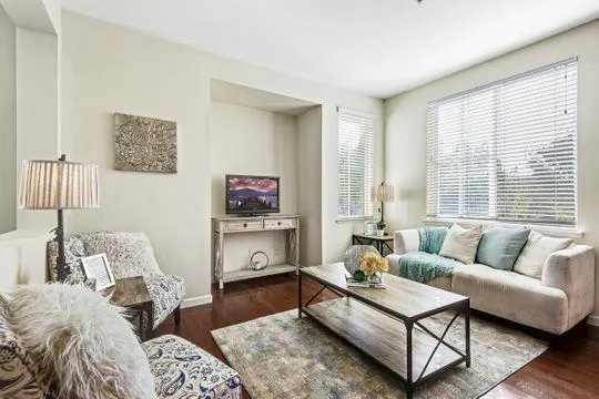 a living room with furniture and a large window