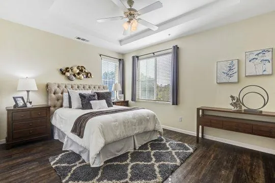 a bedroom with a bed and a chandelier