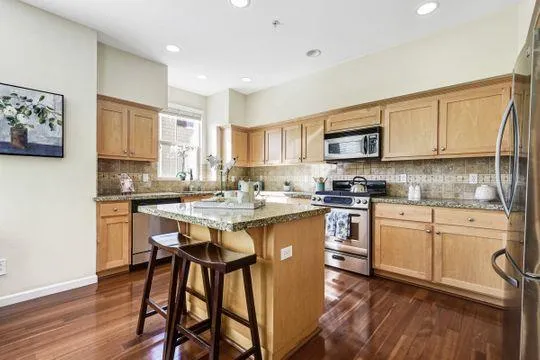 a kitchen with a sink cabinets and wooden floor