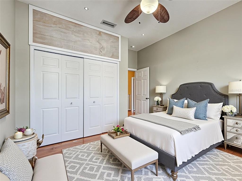 1801 Highland Road Osprey, FL 34229 - Photo 26 of 40 a bedroom with a bed and a lamp