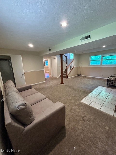 17510 Munn Road Chagrin Falls, OH 44023 - Photo 9 of 35 Carpeted living area with a textured ceiling, stairway, visible vents, and baseboards