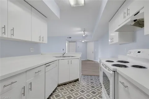 a kitchen with a sink and cabinets