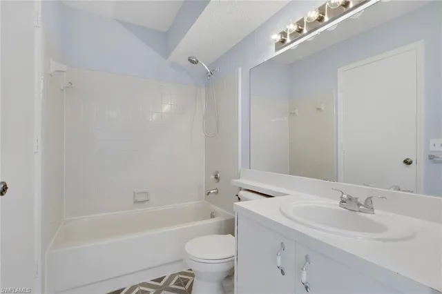 a bathroom with a sink a toilet and a large mirror