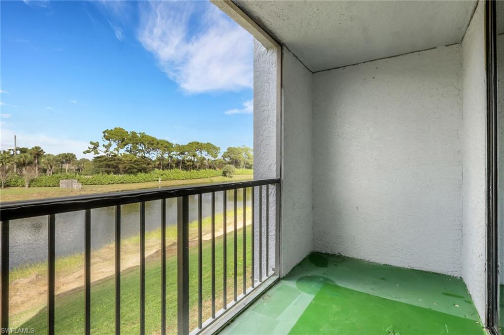 13565 Eagle Ridge Drive, Unit 1124 Fort Myers, FL 33912 - Photo 25 of 49 Balcony featuring a sunroom, view of scattered trees, and a water view
