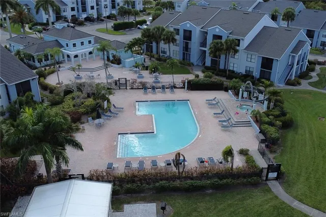 an aerial view of a house with outdoor space and lake view