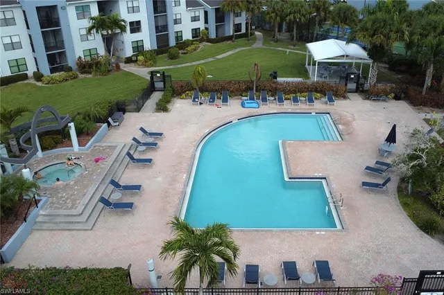 an aerial view of a house with swimming pool garden and patio