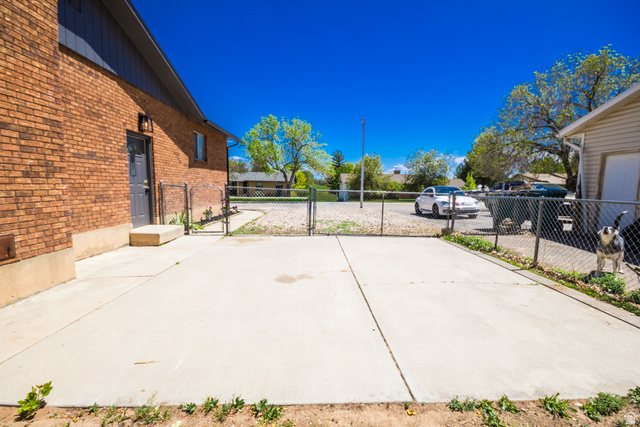634 South 2100th Street West Vernal, UT 84078 - Photo 53 of 71 Expansive concrete patio area with chain-link fencing