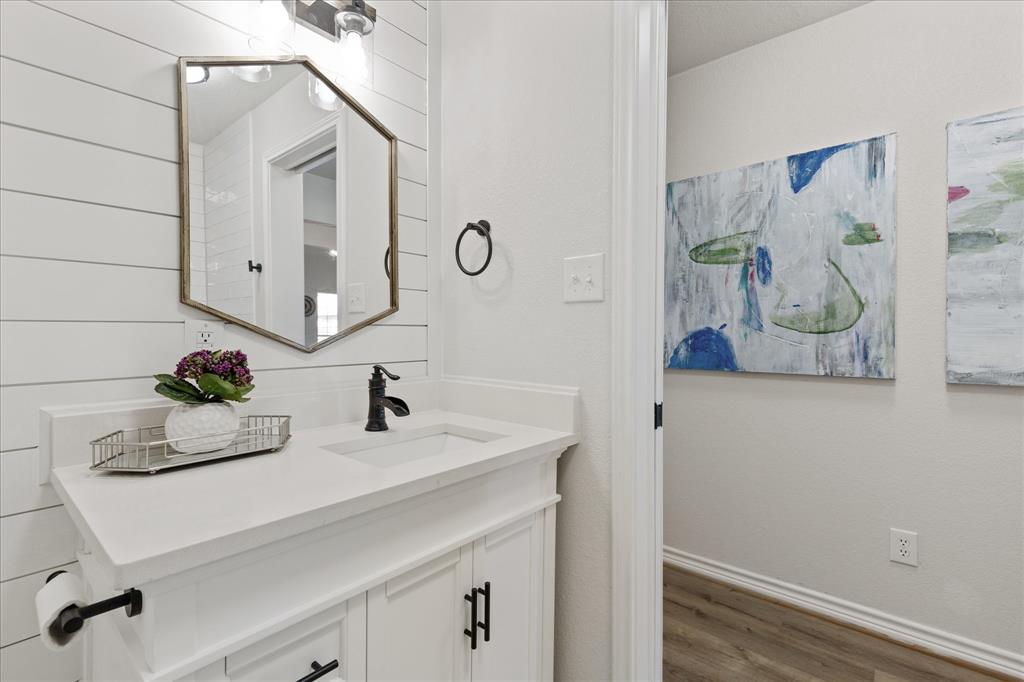 4309 Davis Road Granbury, TX 76049 - Photo 18 of 40 a bathroom with a sink and a mirror