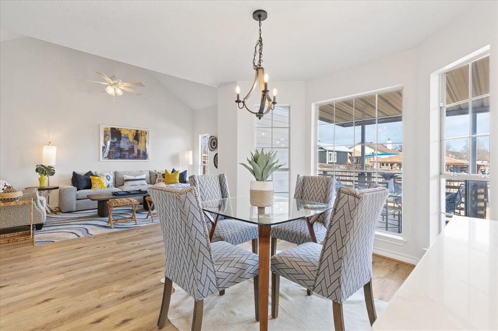 4309 Davis Road Granbury, TX 76049 - Photo 8 of 40 a dining room with furniture a chandelier and wooden floor