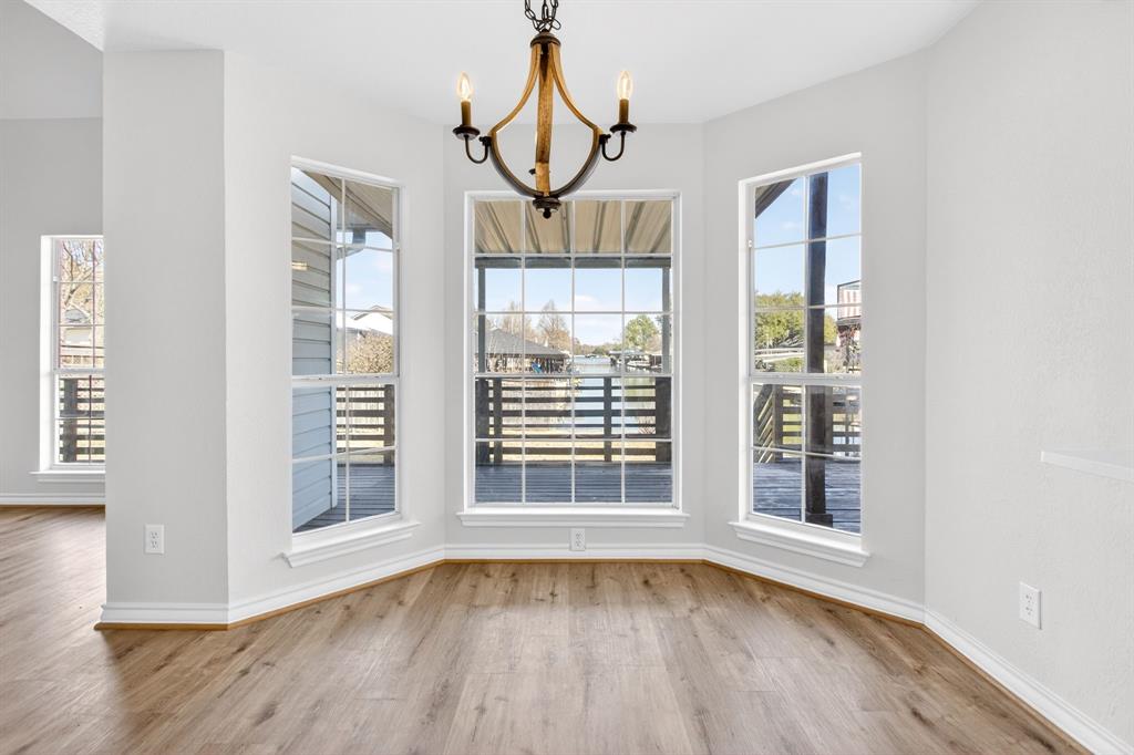 4309 Davis Road Granbury, TX 76049 - Photo 9 of 40 a view of an empty room with wooden floor and a window
