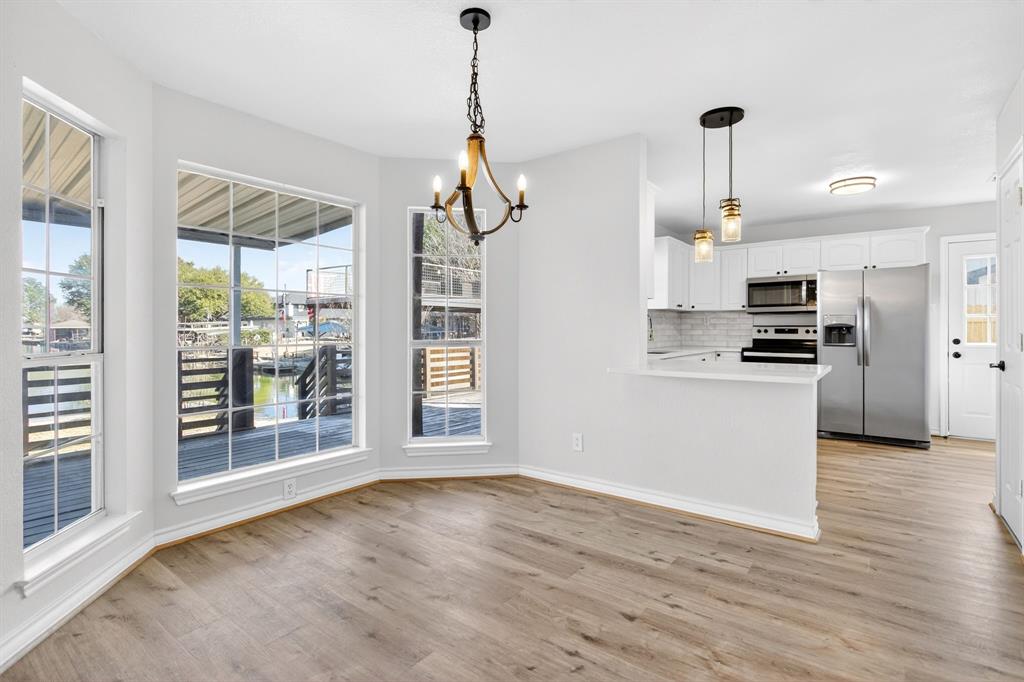4309 Davis Road Granbury, TX 76049 - Photo 10 of 40 a view of empty room with wooden floor and stove
