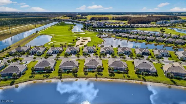 an aerial view of residential houses with outdoor space and swimming pool